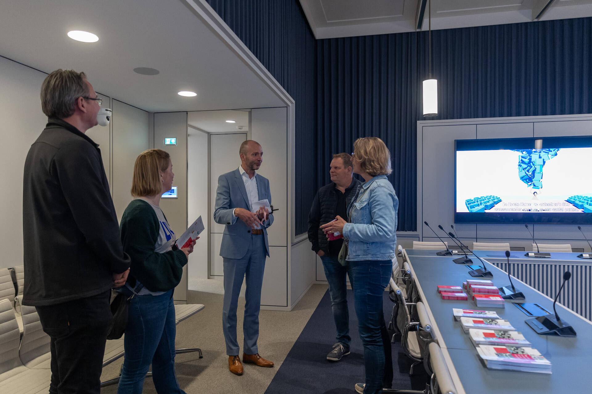 Foto van een Commissiekamer waarin mensen uitleg krijgen